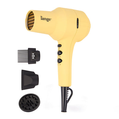 yellow L'ange hair dryer with three included attachments (comb, concentrator, diffuser) displayed beside it.