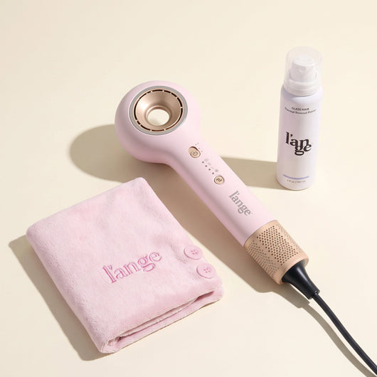 L'ange pink Axia HaloRing hair dryer, blush microfiber towel, Glass Hair Thermal Blowout Primer on a beige background.