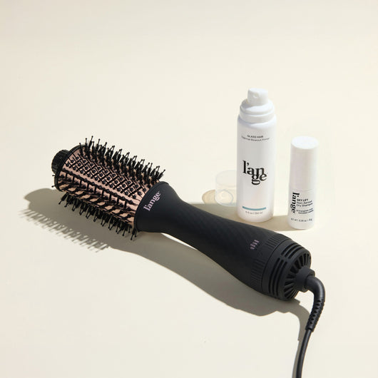 The Fresh Blowout Trio Value Set featuring a Black 60mm Le Volume,  Glass Hair, and Sky Lift, displayed on a beige background.
